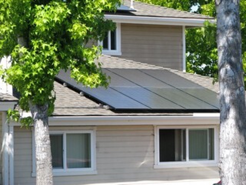 Solar panels sit on the roof of the Leland Park Apartments