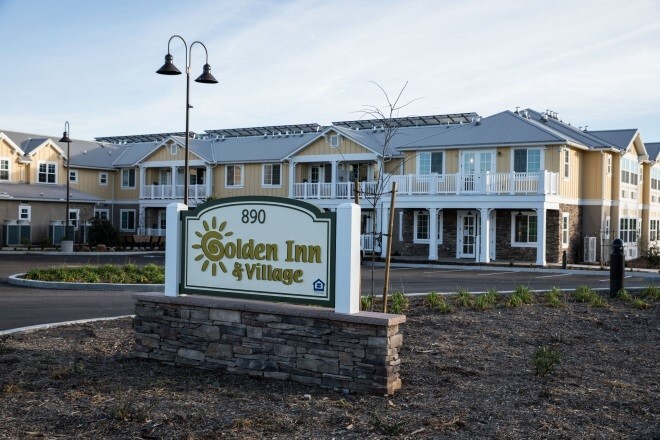 the Golden Inn Village sign and apartments