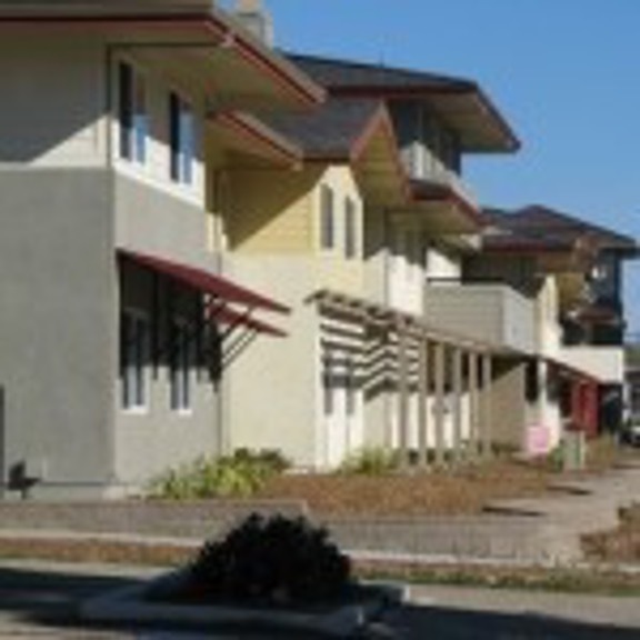 Santa Rita Village apartments sit against a sunny sky