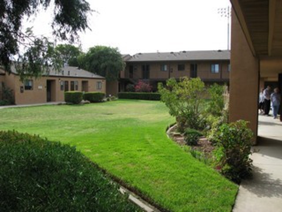 Beautiful grass and landscaping leads to the Parkside Garden Apartments. 