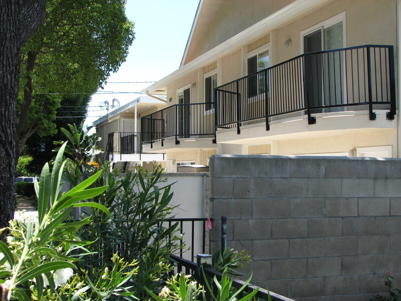 Balconies are lined with smooth and modern black railings.