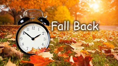 Fall leaves on ground with clock and words Fall Back