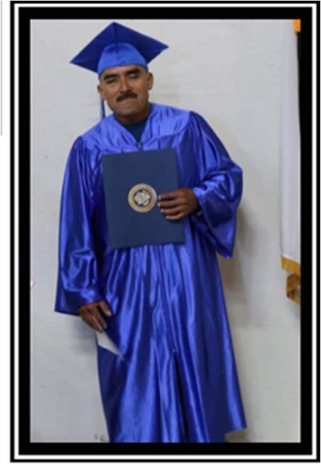 Jesus L. in a cap and gown