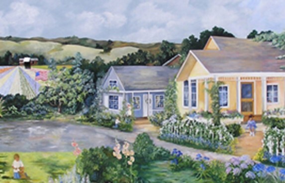 painted mural of 2 cottages with flowers next to pond with rolling hills